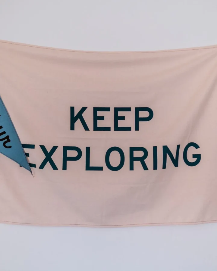 Printed fabric banner reading Keep Exploring