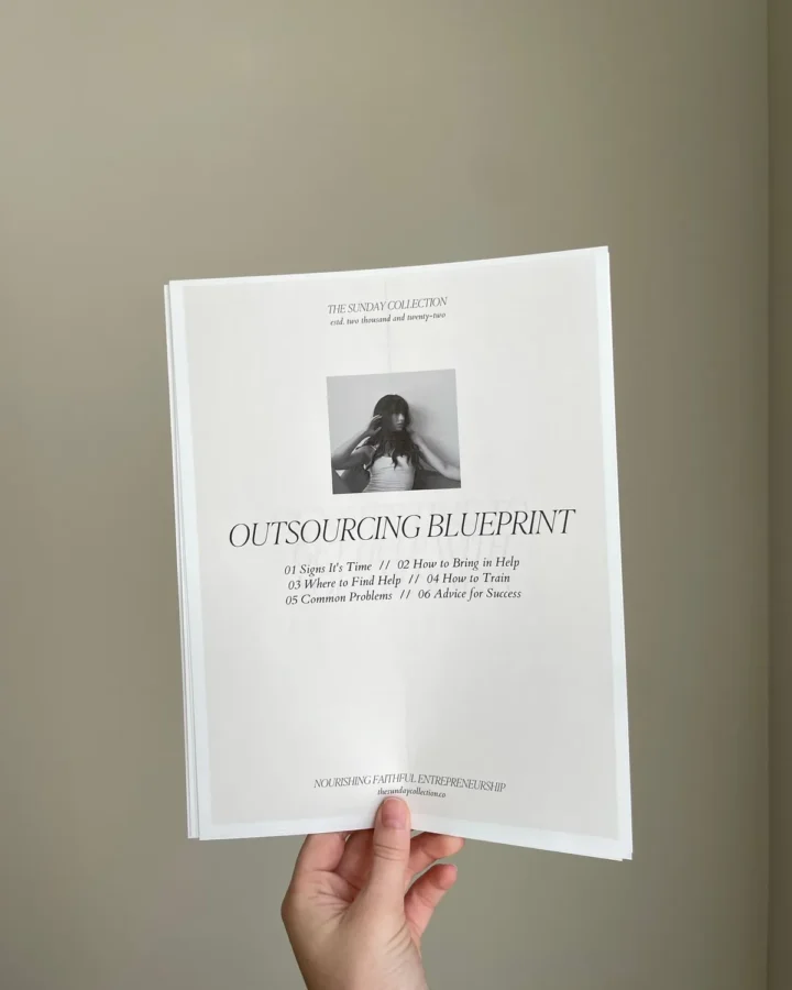 Hand holding a printed saddle stitched booklet
