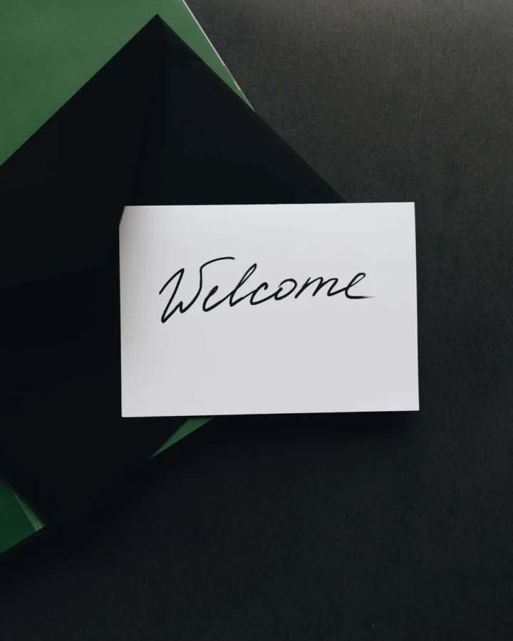 Printed welcome card in a dark envelope
