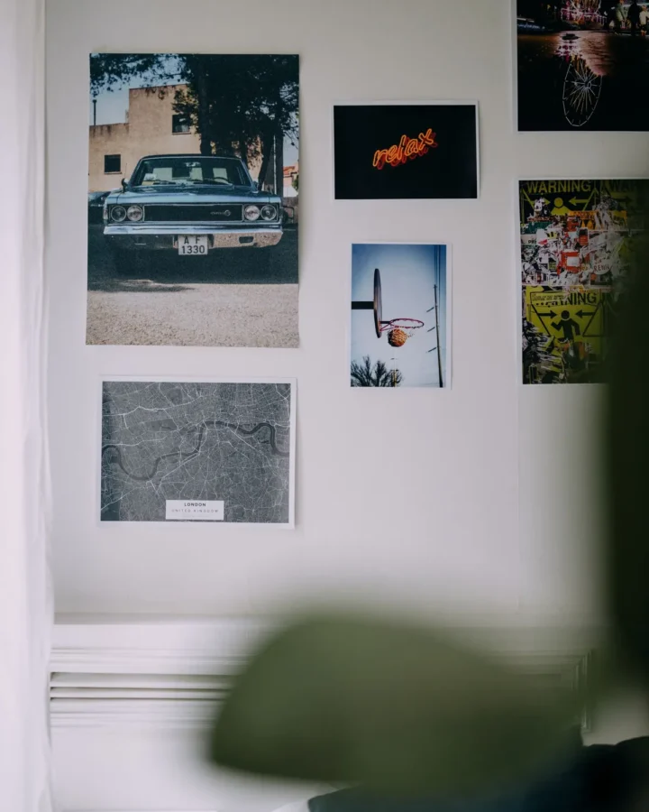 Framed photo posters on a white wall